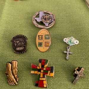 Seven religious icon lapel pins.